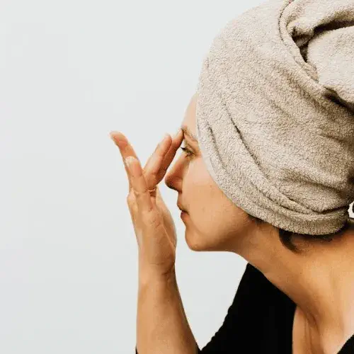 A Woman in Black Shirt Covering Her Head With Gray Towel